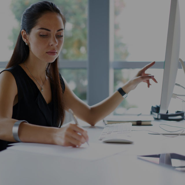 Woman taking notes in an office
