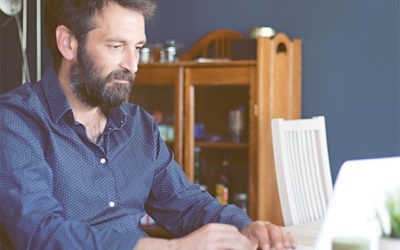 man using laptop at home